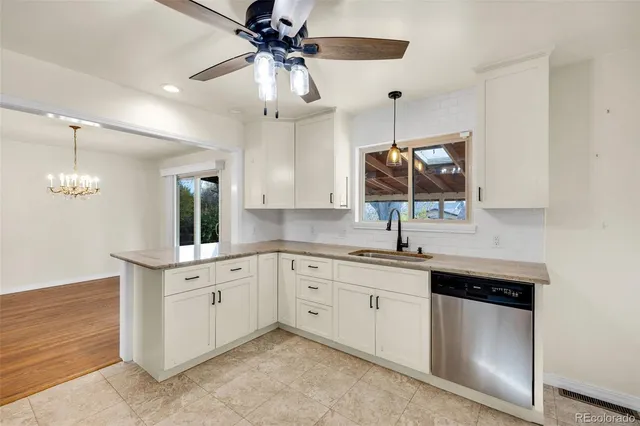 a kitchen with stainless steel appliances a stove sink and microwave