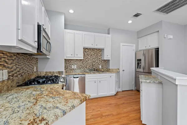 a view of kitchen and kitchen with wooden floor