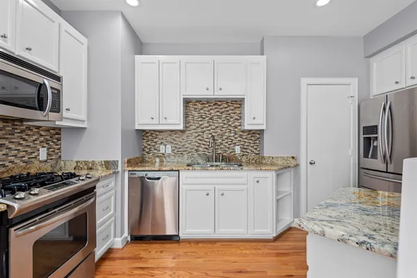 a kitchen with a refrigerator sink and stove