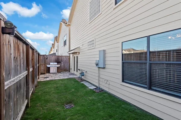 a backyard of a house with chairs and outdoor seating