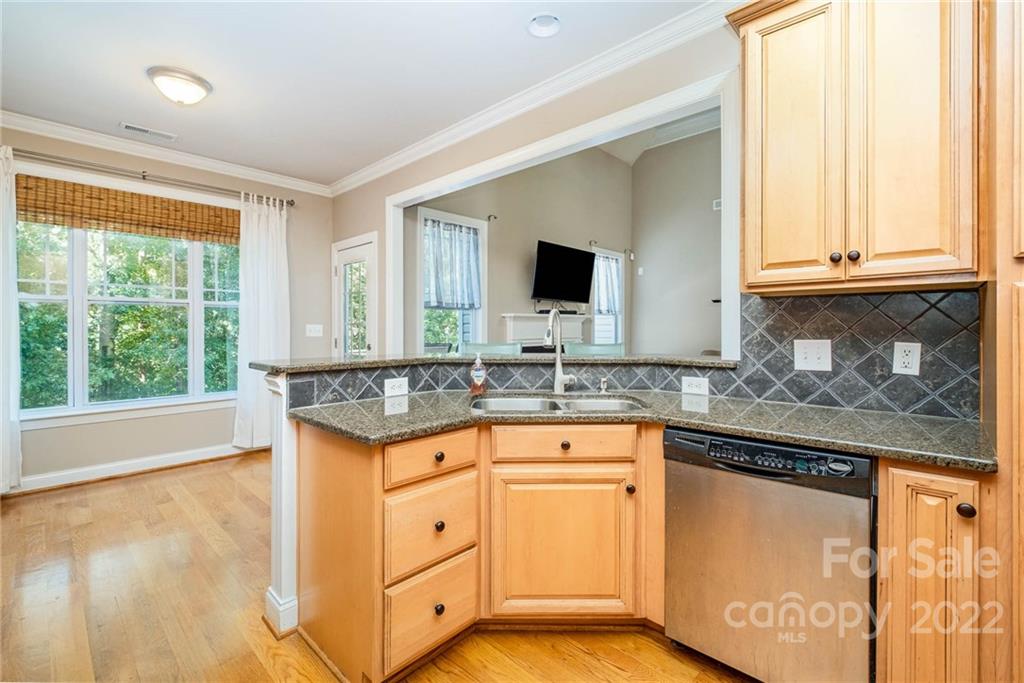 5712 Davis Road Waxhaw, NC 28173 - Photo 16 of 43 a kitchen with granite countertop a sink and a window