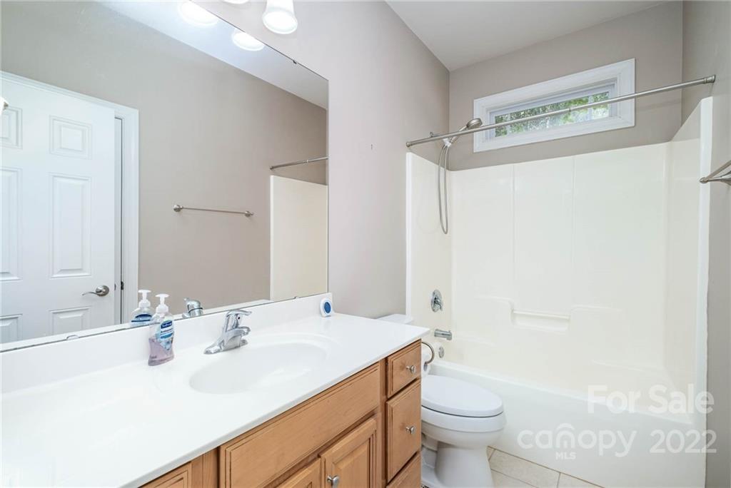5712 Davis Road Waxhaw, NC 28173 - Photo 18 of 43 a bathroom with a sink a toilet and shower