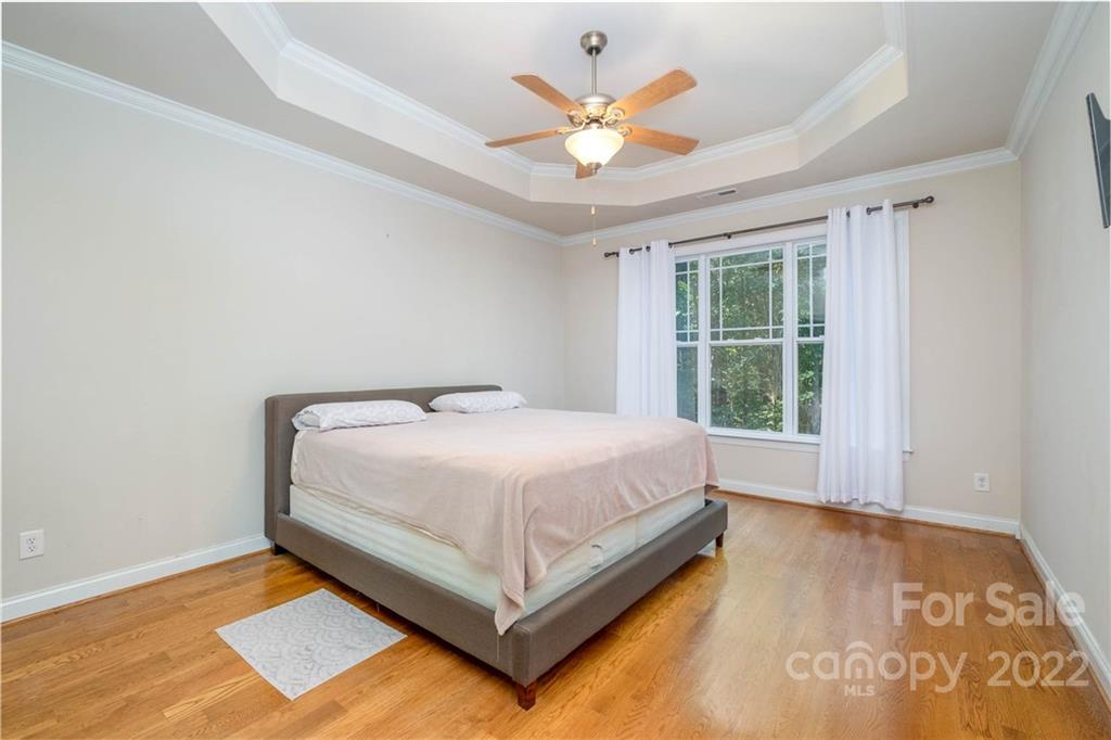 5712 Davis Road Waxhaw, NC 28173 - Photo 21 of 43 a spacious bedroom with a bed and a large window