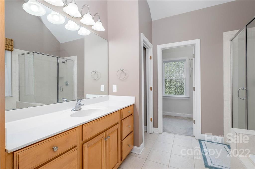 5712 Davis Road Waxhaw, NC 28173 - Photo 23 of 43 a bathroom with a sink a vanity and a large mirror