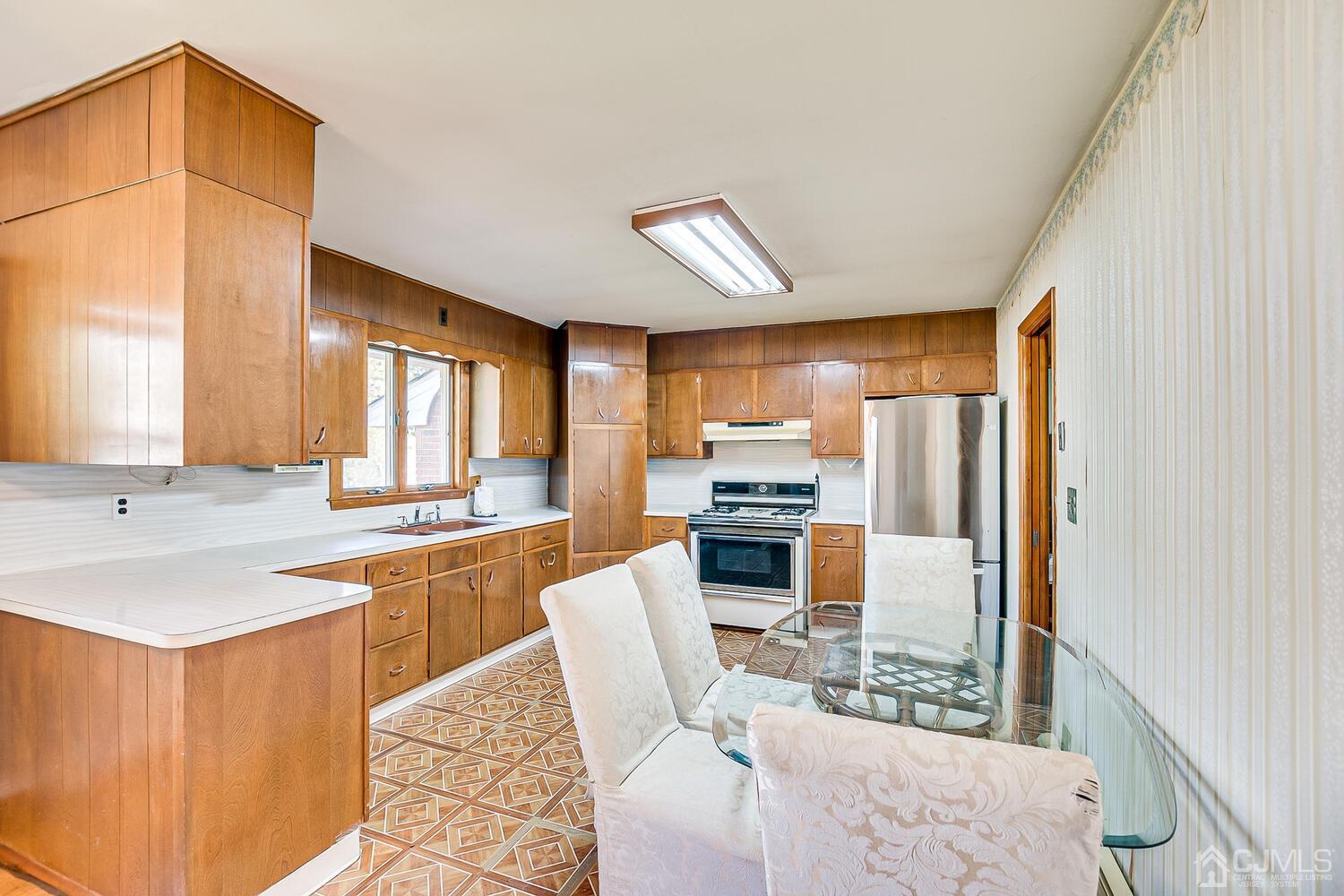 1037 Hamilton Street Somerset, NJ 08873 - Photo 11 of 29 a large kitchen with a table and chairs in it