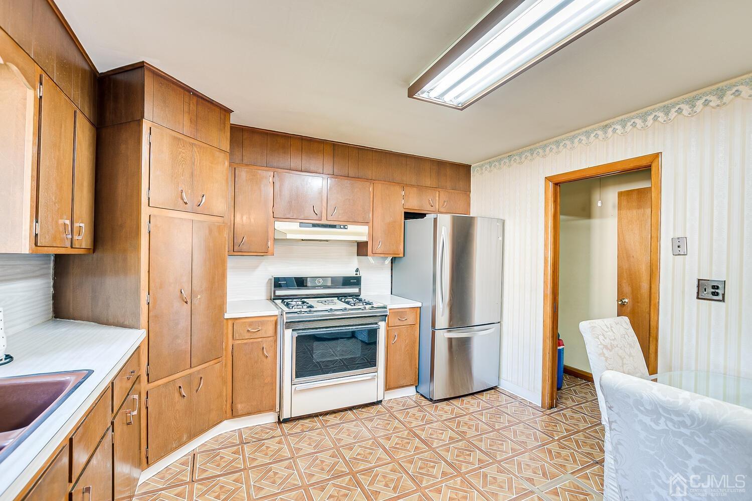 1037 Hamilton Street Somerset, NJ 08873 - Photo 12 of 29 a kitchen with stainless steel appliances granite countertop a refrigerator stove and sink