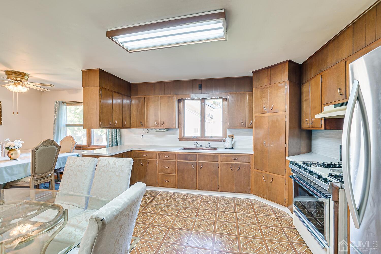1037 Hamilton Street Somerset, NJ 08873 - Photo 14 of 29 a kitchen with stainless steel appliances granite countertop a stove a sink and a refrigerator