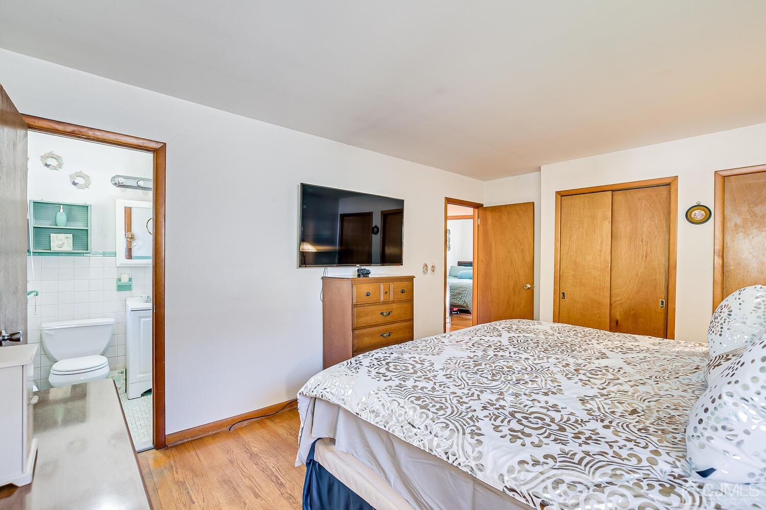 1037 Hamilton Street Somerset, NJ 08873 - Photo 15 of 29 a bedroom with a bed and a flat screen tv