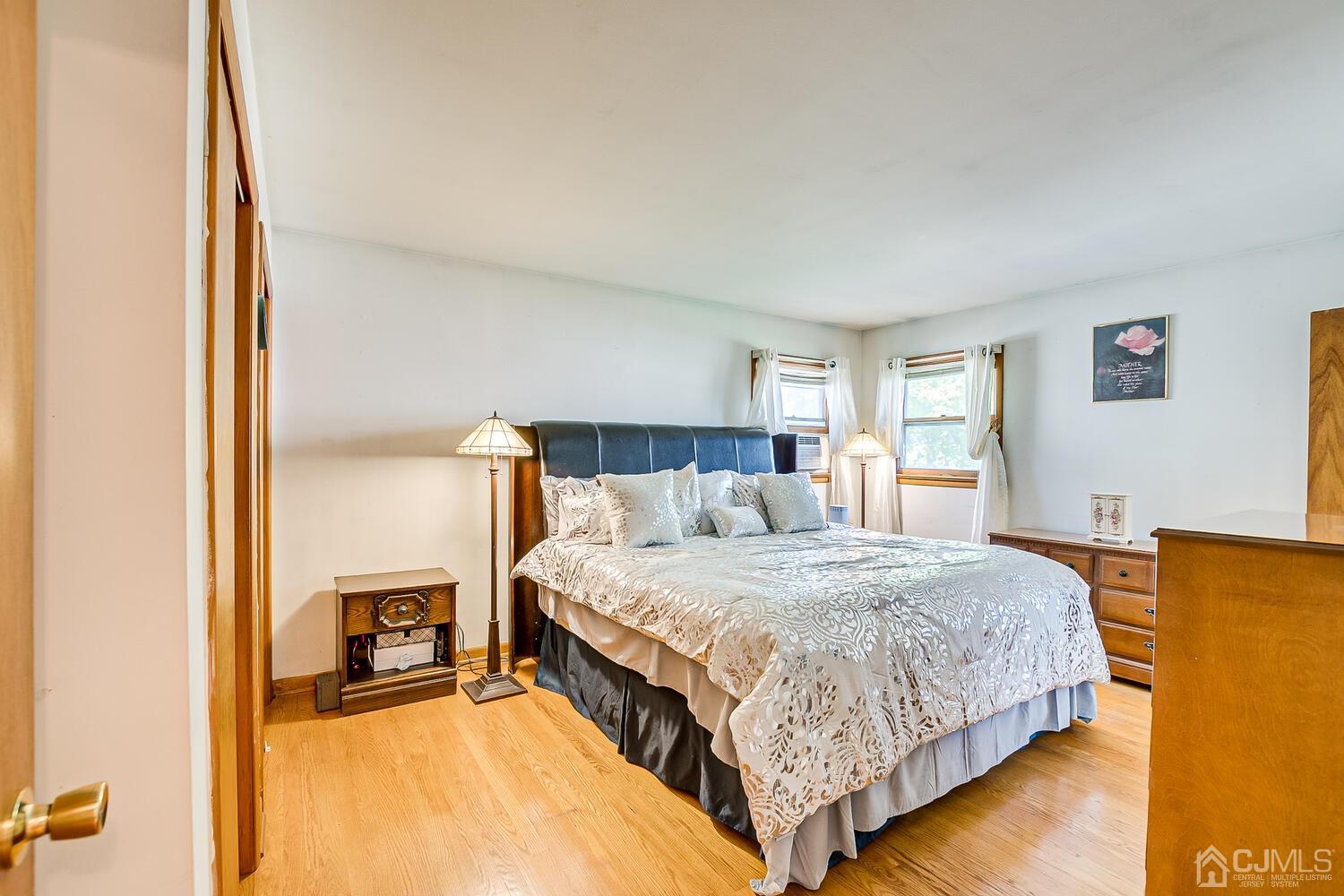 1037 Hamilton Street Somerset, NJ 08873 - Photo 16 of 29 a bedroom with a bed and wooden floor