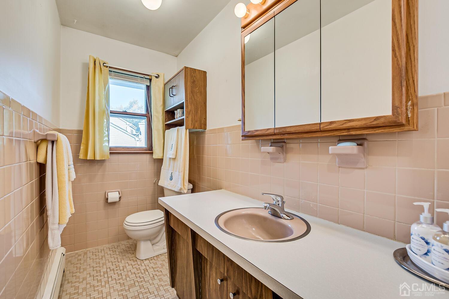 1037 Hamilton Street Somerset, NJ 08873 - Photo 21 of 29 a bathroom with a granite countertop sink and a toilet