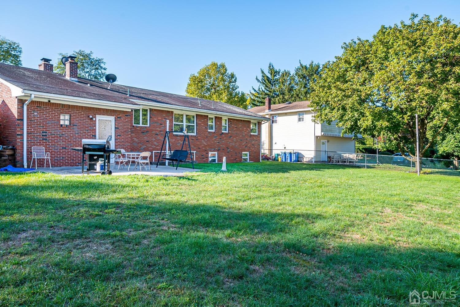 1037 Hamilton Street Somerset, NJ 08873 - Photo 25 of 29 a front view of a house with a yard and a tree