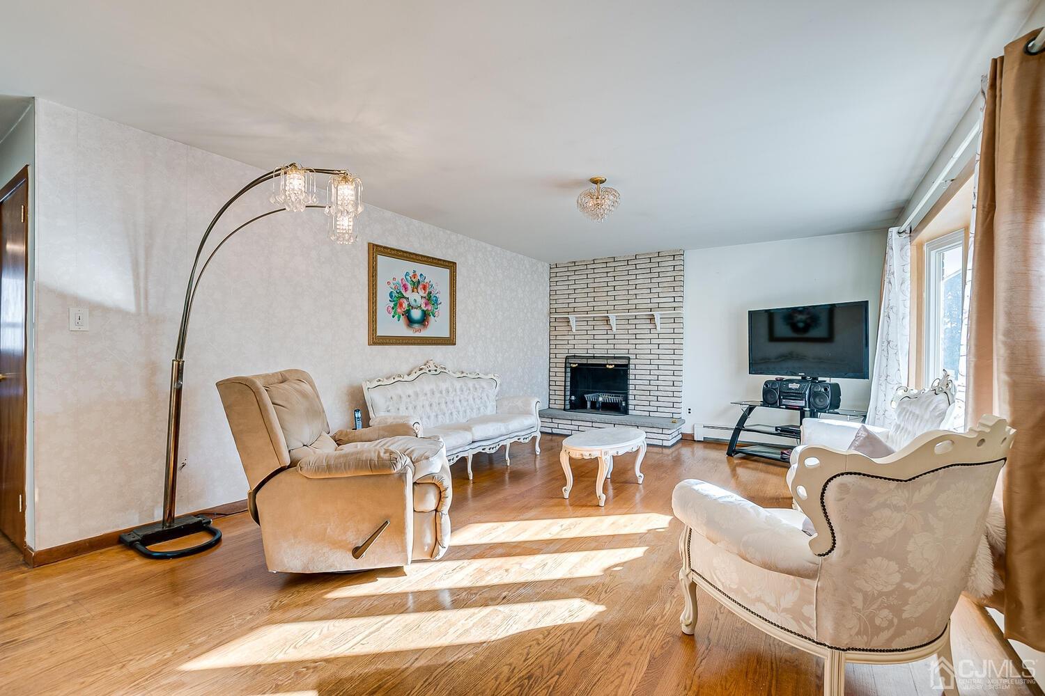 1037 Hamilton Street Somerset, NJ 08873 - Photo 5 of 29 a living room with furniture and a fireplace