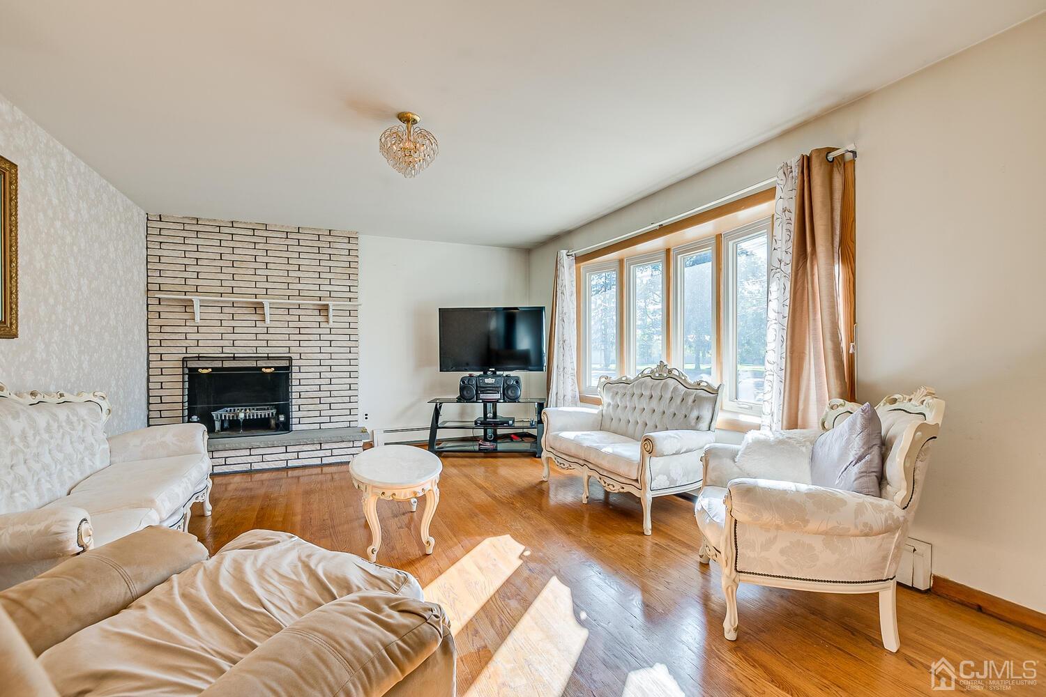 1037 Hamilton Street Somerset, NJ 08873 - Photo 6 of 29 a living room with furniture large window and a flat screen tv