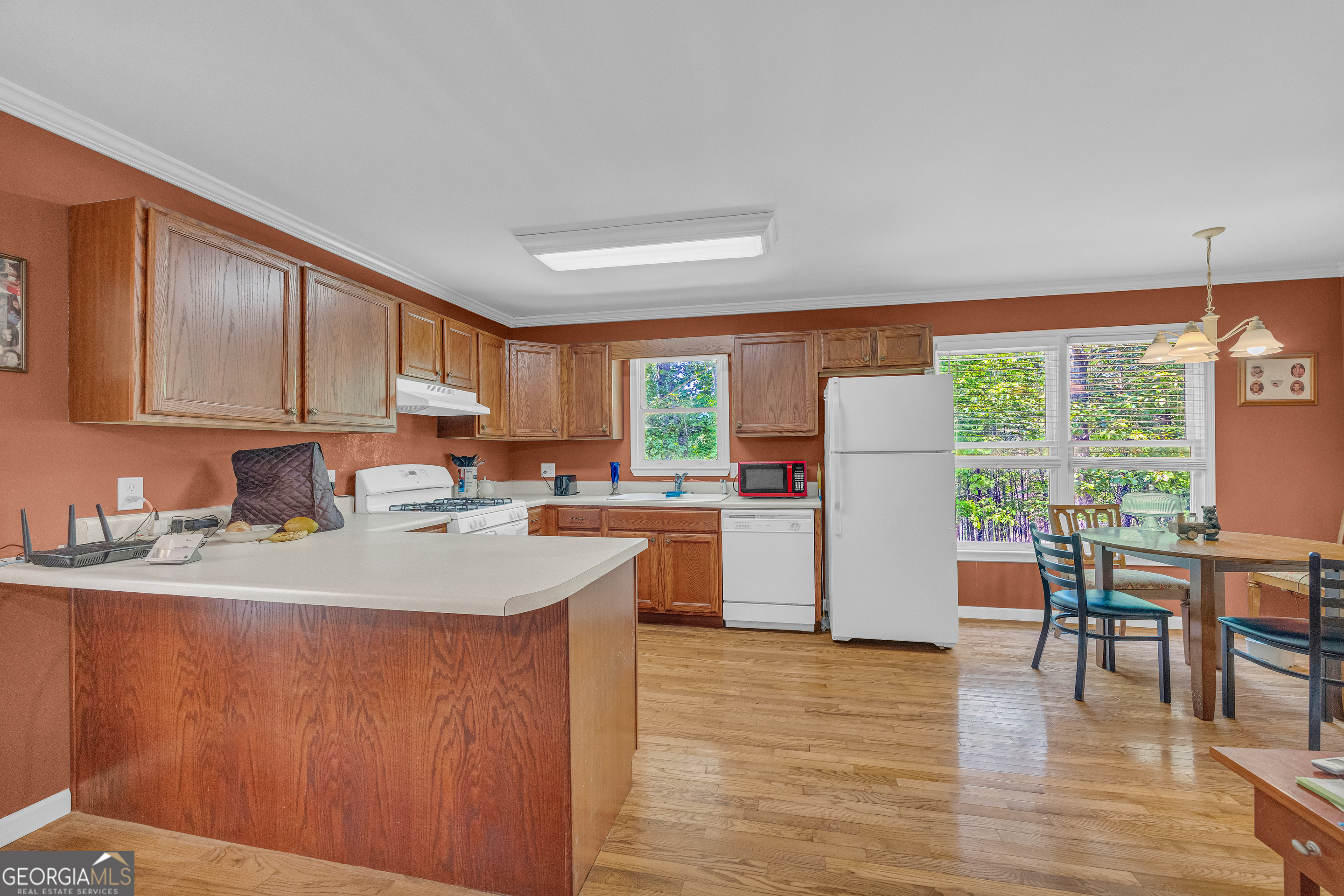 807 Satterfield Road Cleveland, GA 30528 - Photo 24 of 99 a kitchen with stainless steel appliances granite countertop a refrigerator a sink dishwasher a stove and a dining table with wooden floor