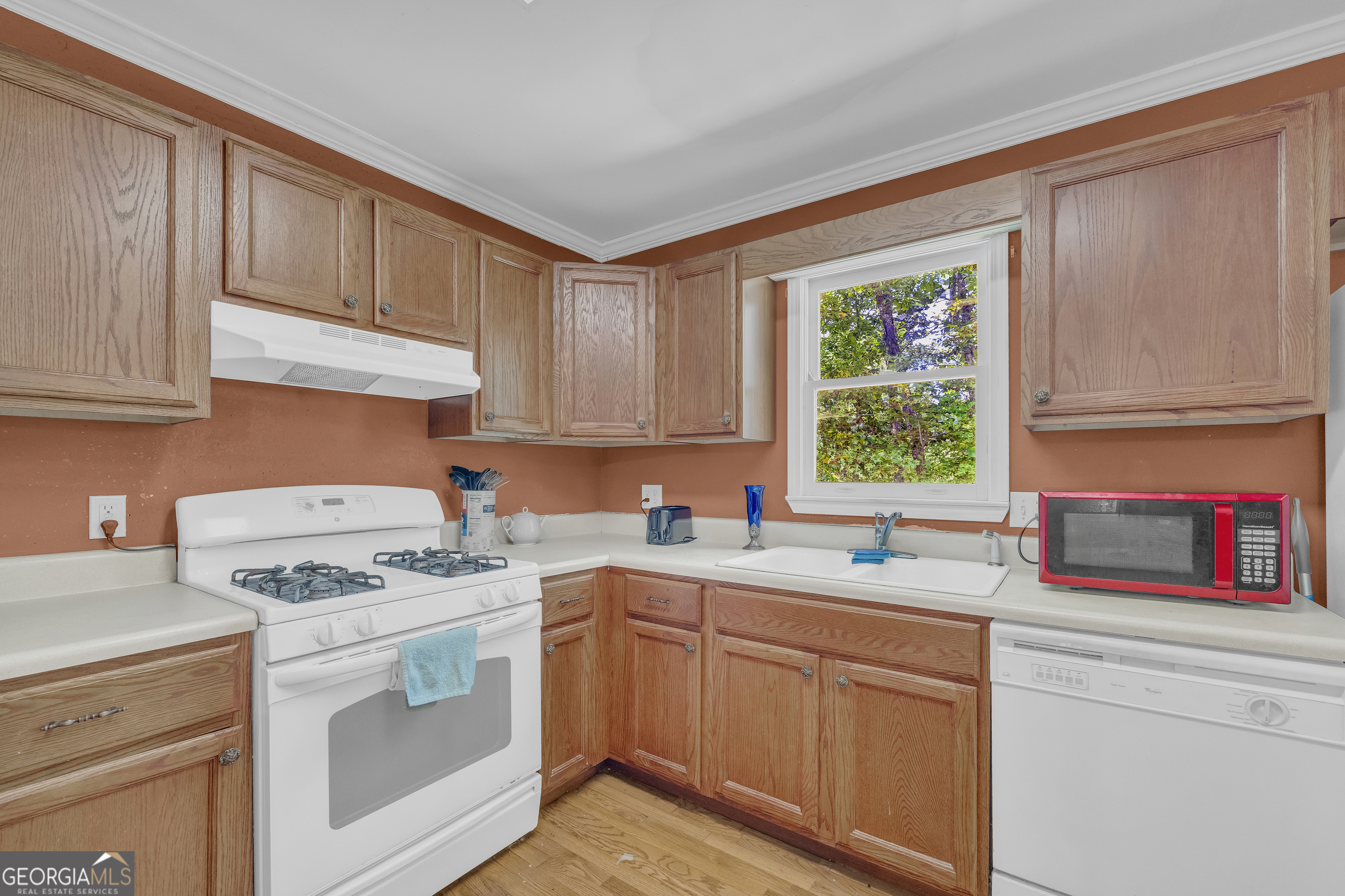 807 Satterfield Road Cleveland, GA 30528 - Photo 26 of 99 a kitchen with stainless steel appliances white cabinets sink and window