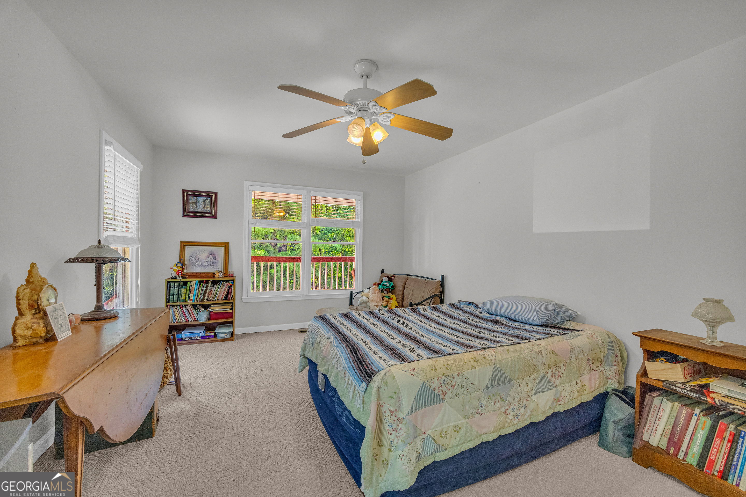 807 Satterfield Road Cleveland, GA 30528 - Photo 32 of 99 a bedroom with a bed and a chandelier