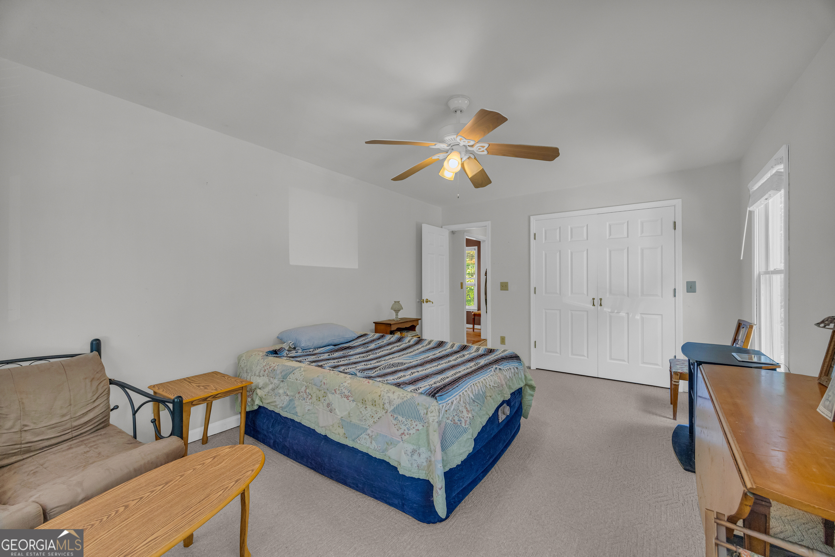 807 Satterfield Road Cleveland, GA 30528 - Photo 34 of 99 a bedroom with a bed and a chandelier