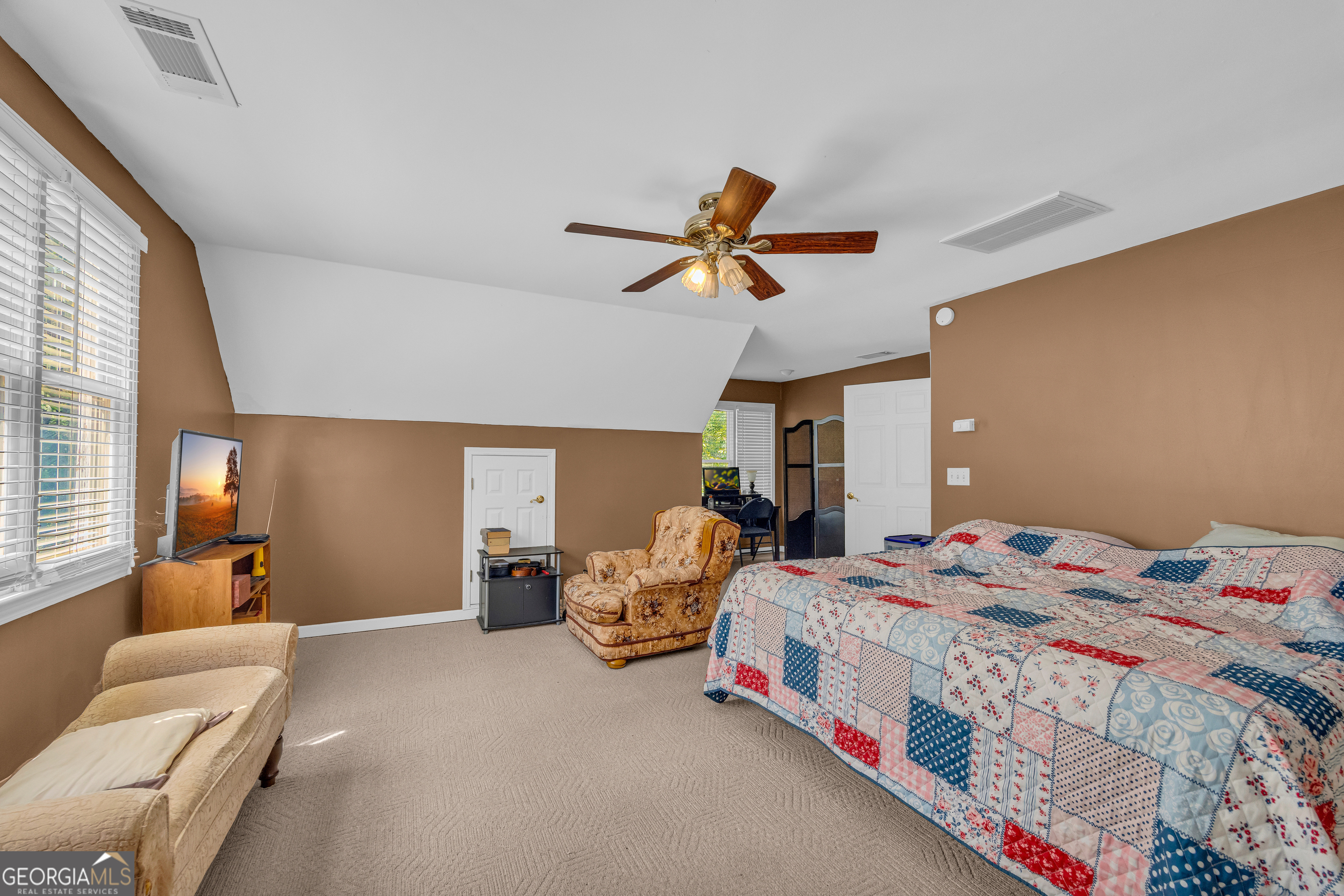 807 Satterfield Road Cleveland, GA 30528 - Photo 42 of 99 a bedroom with a bed and a chandelier