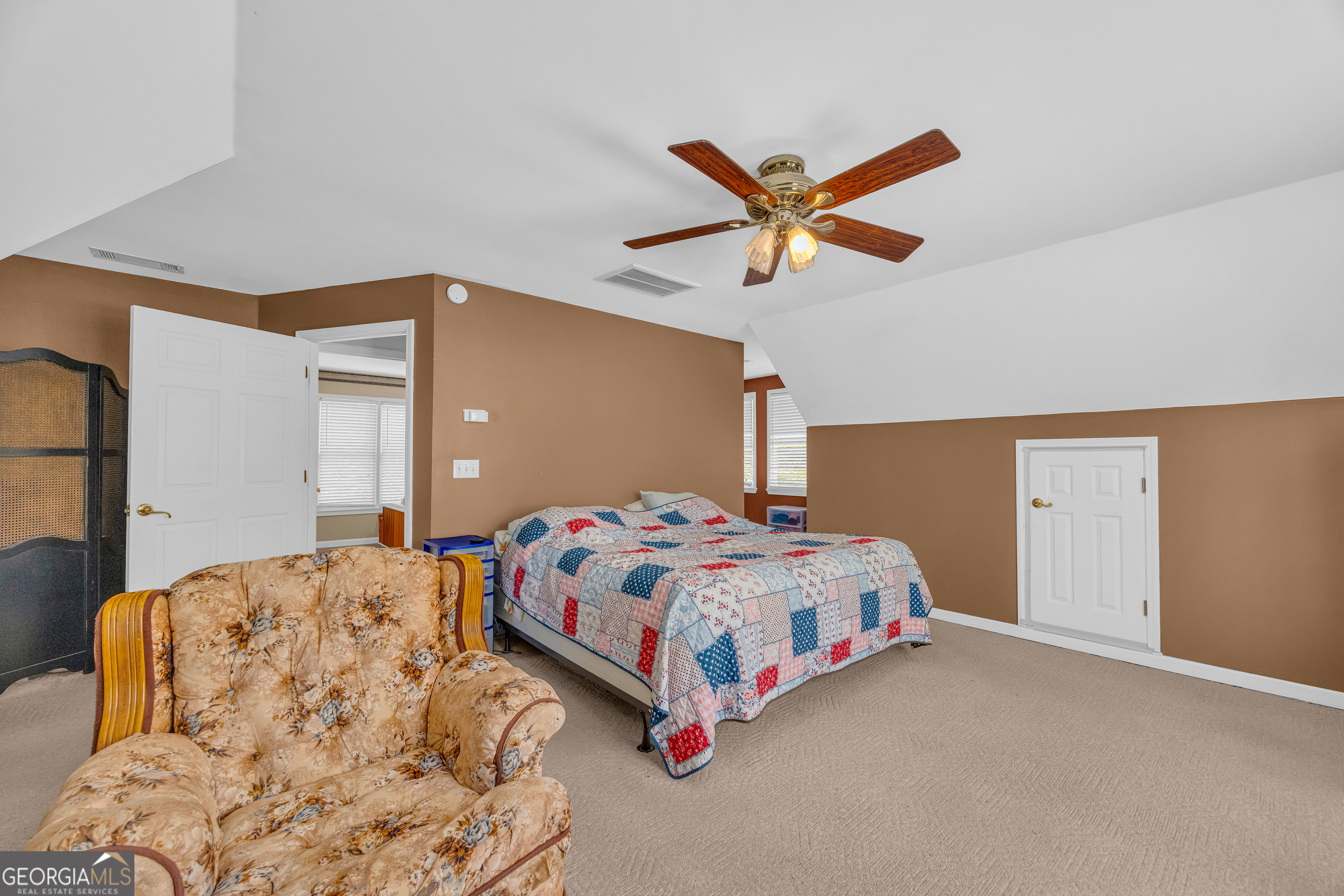 807 Satterfield Road Cleveland, GA 30528 - Photo 43 of 99 a bedroom with a bed and a chandelier