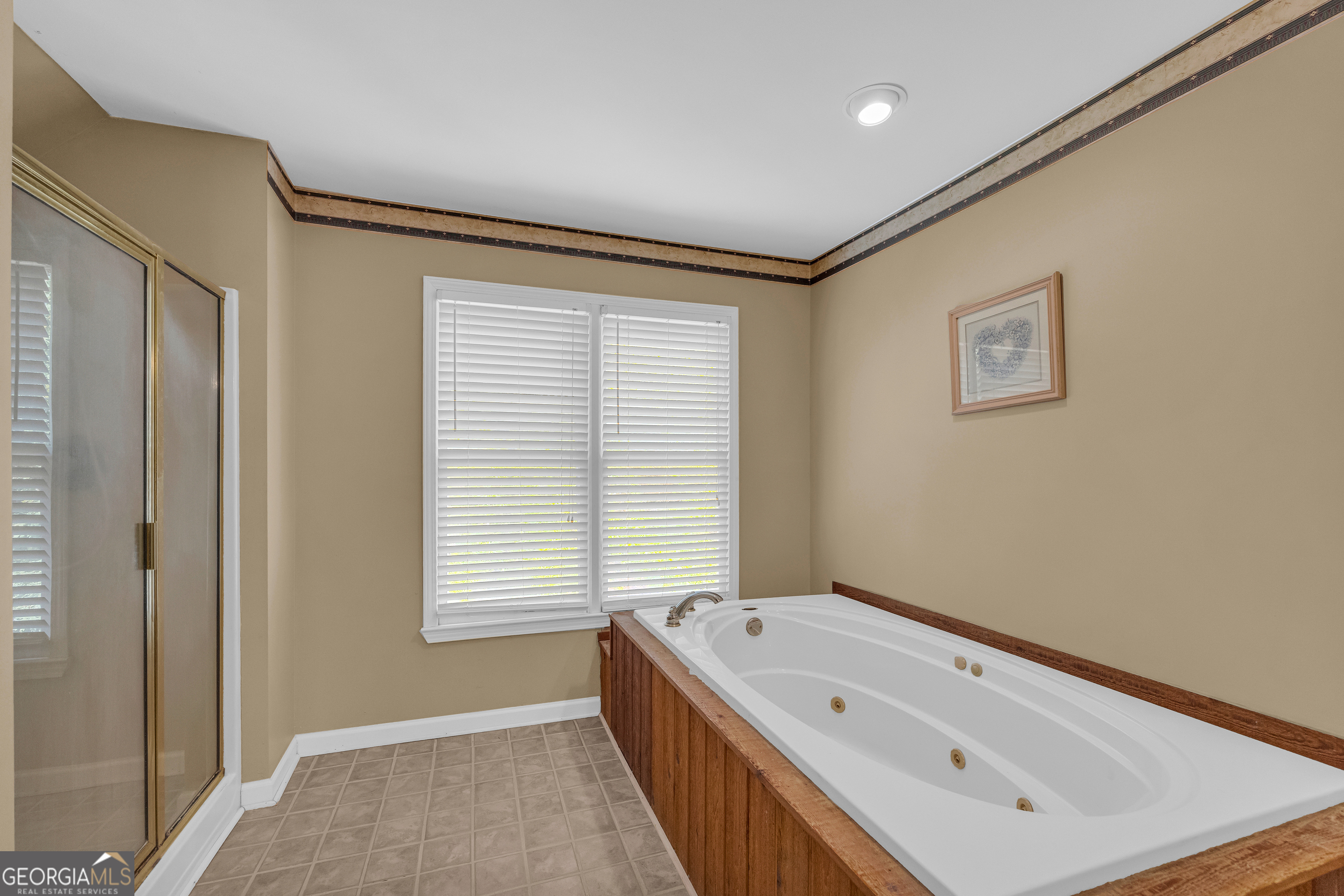 807 Satterfield Road Cleveland, GA 30528 - Photo 48 of 99 a bathroom with a tub a sink and a window