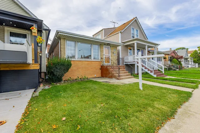 a front view of house with yard and outdoor seating