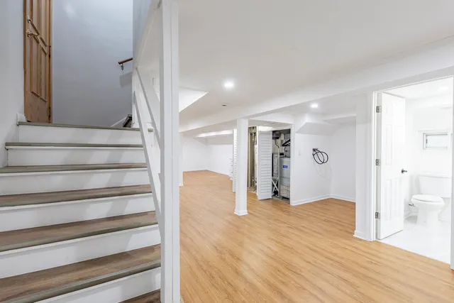 a view of entryway with wooden floor and stairs