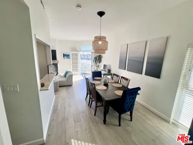 a dining room with furniture a chandelier and wooden floor