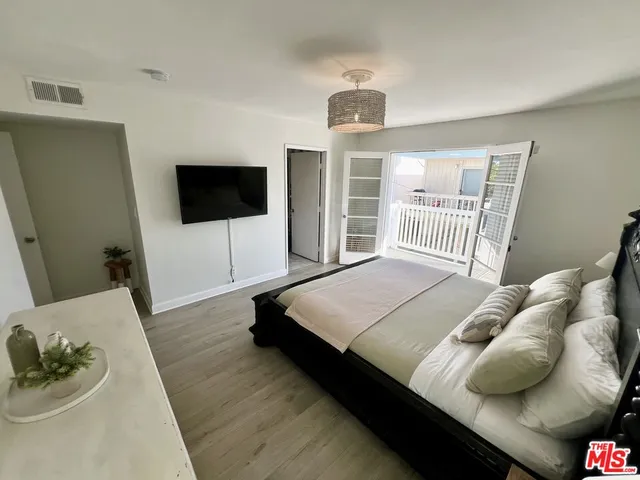 a bedroom with a bed and a flat screen tv