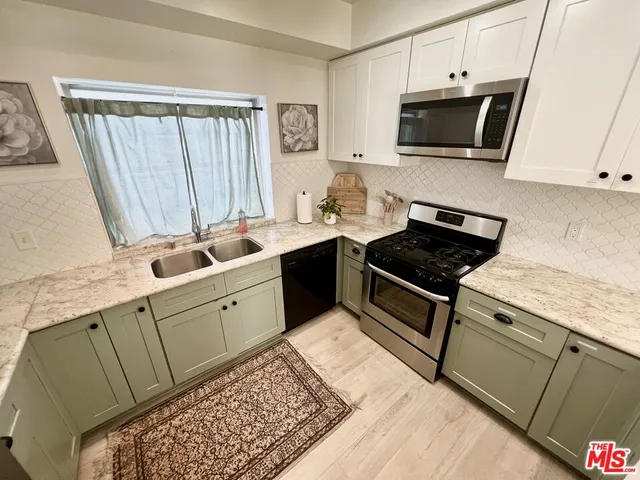a kitchen with a sink stove and microwave