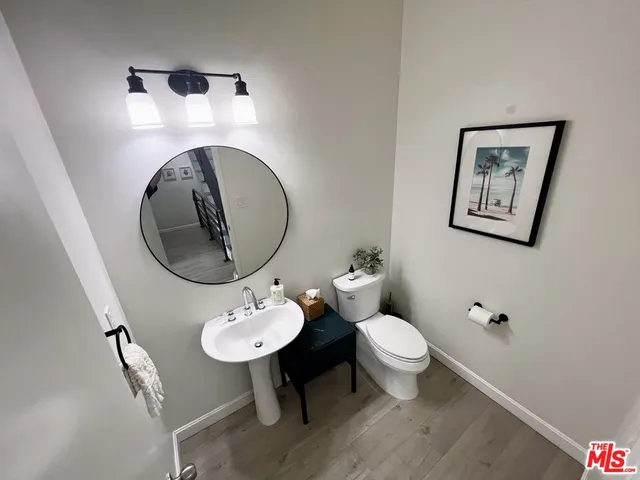 a bathroom with a toilet a sink and mirror