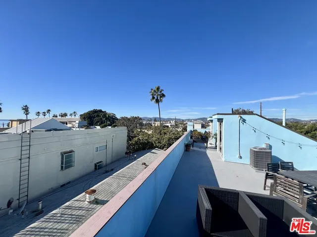 a view of a balcony with wooden floor