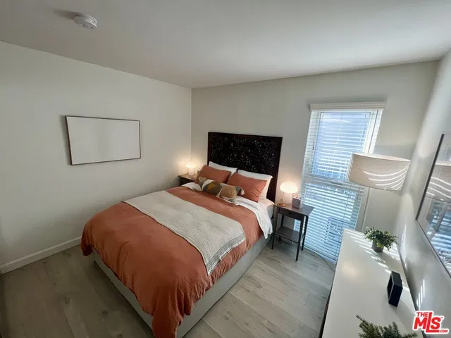 a bed room with a bed and a painting