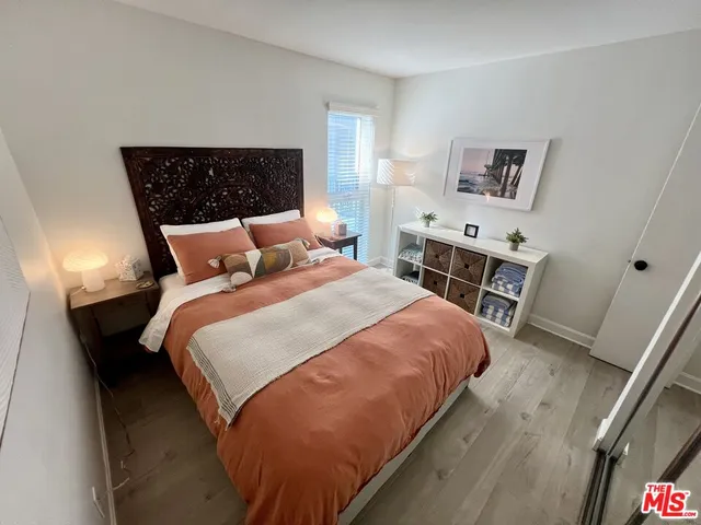 a bedroom with a bed and a night stand
