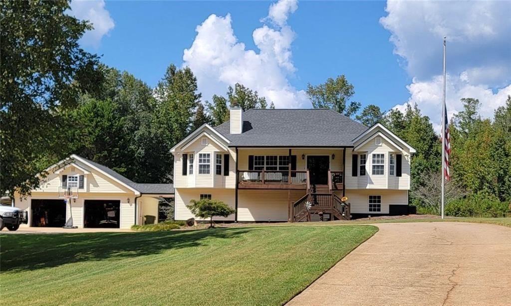 a front view of a house with a yard and garage