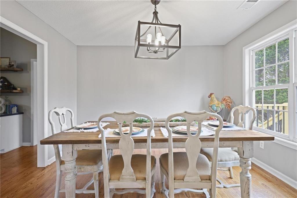 342 Miller Path Temple, GA 30179 - Photo 11 of 47 a view of a dining room with furniture a chandelier and wooden floor
