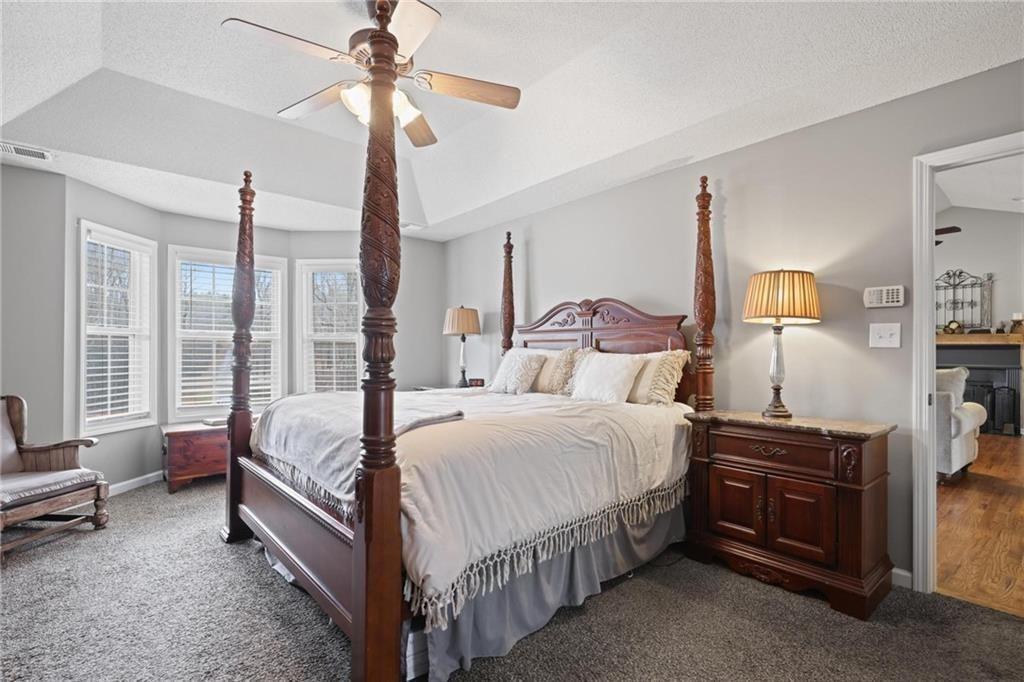 342 Miller Path Temple, GA 30179 - Photo 15 of 47 a bedroom with a bed and a chandelier