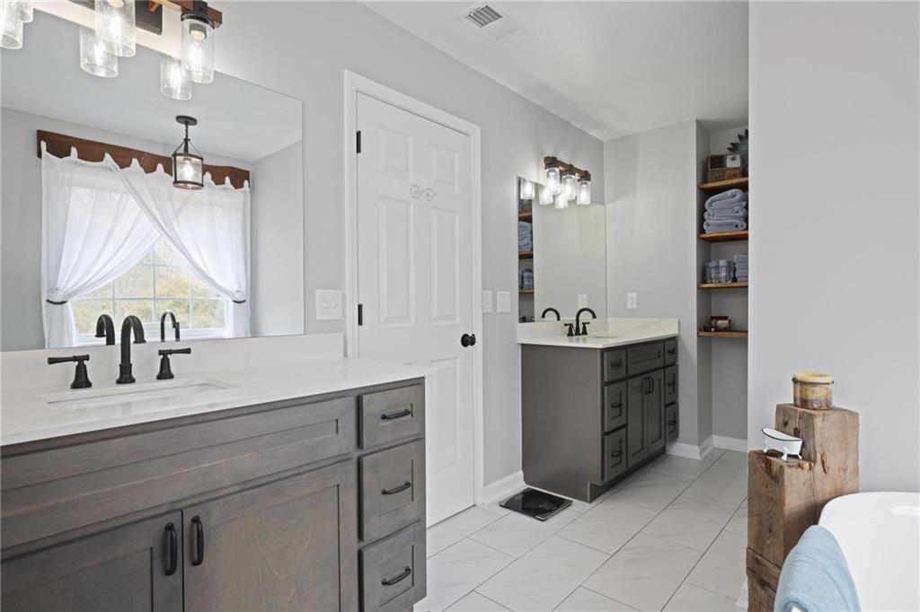342 Miller Path Temple, GA 30179 - Photo 16 of 47 a bathroom with a sink double vanity and a mirror