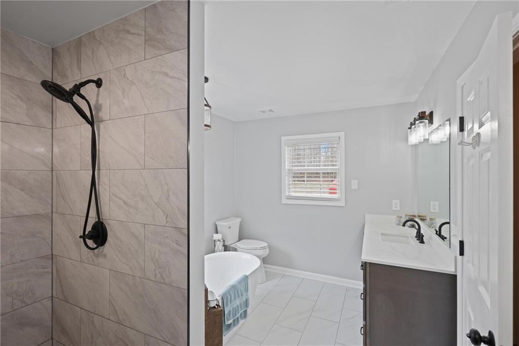 342 Miller Path Temple, GA 30179 - Photo 20 of 47 a bathroom with a granite countertop shower a sink and a toilet