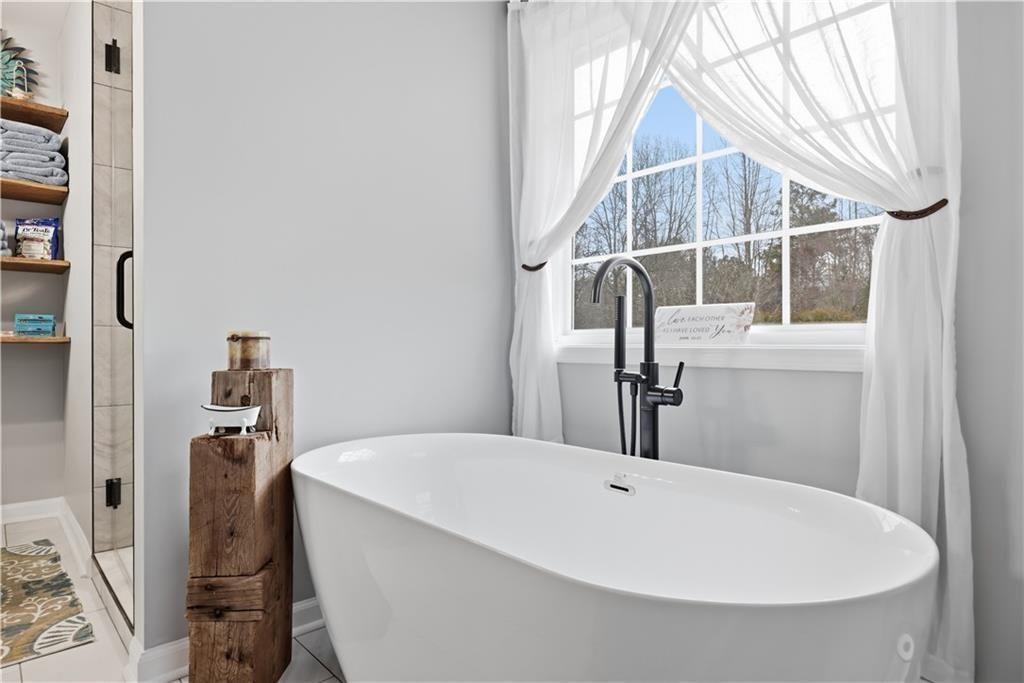 342 Miller Path Temple, GA 30179 - Photo 21 of 47 a bathroom with a bathtub and a window