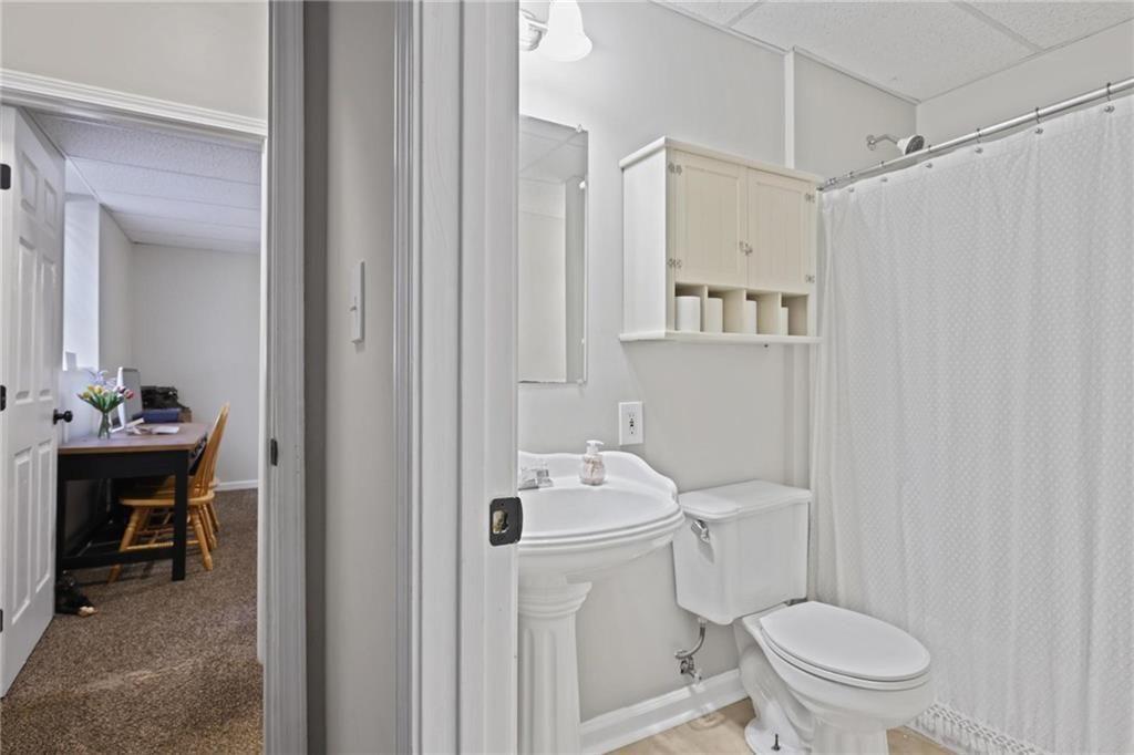 342 Miller Path Temple, GA 30179 - Photo 29 of 47 a bathroom with a sink a toilet and shower curtain