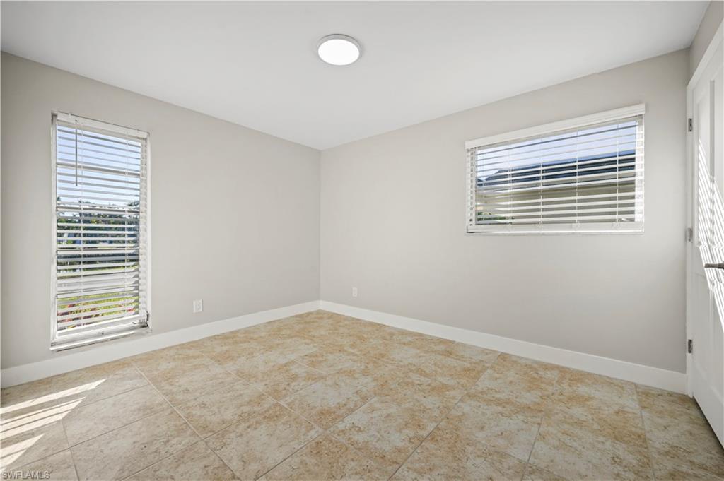 3 Kings Road, Unit A7 Naples, FL 34112 - Photo 10 of 20 Spare room with light tile patterned floors