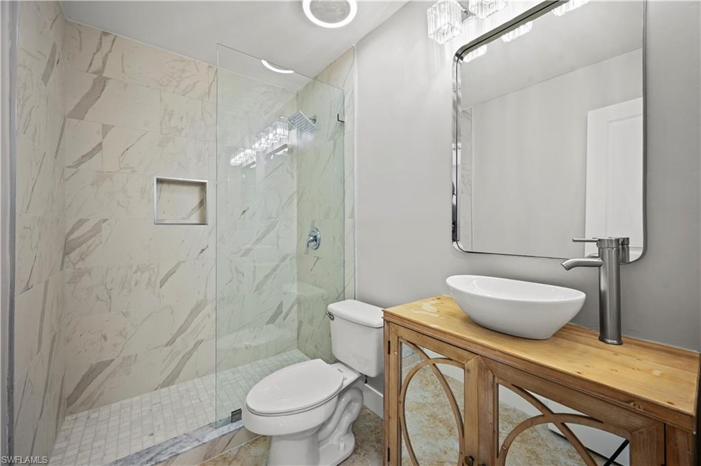 3 Kings Road, Unit A7 Naples, FL 34112 - Photo 15 of 20 Bathroom featuring a marble finish shower and vanity
