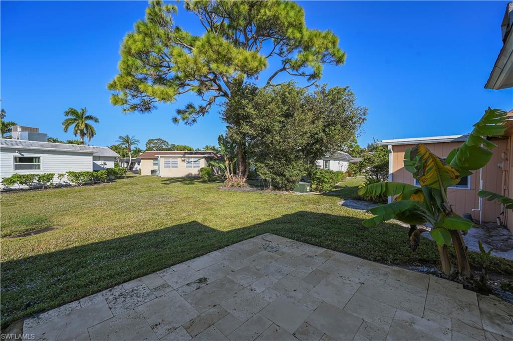 3 Kings Road, Unit A7 Naples, FL 34112 - Photo 17 of 20 View of grassy yard featuring a patio area