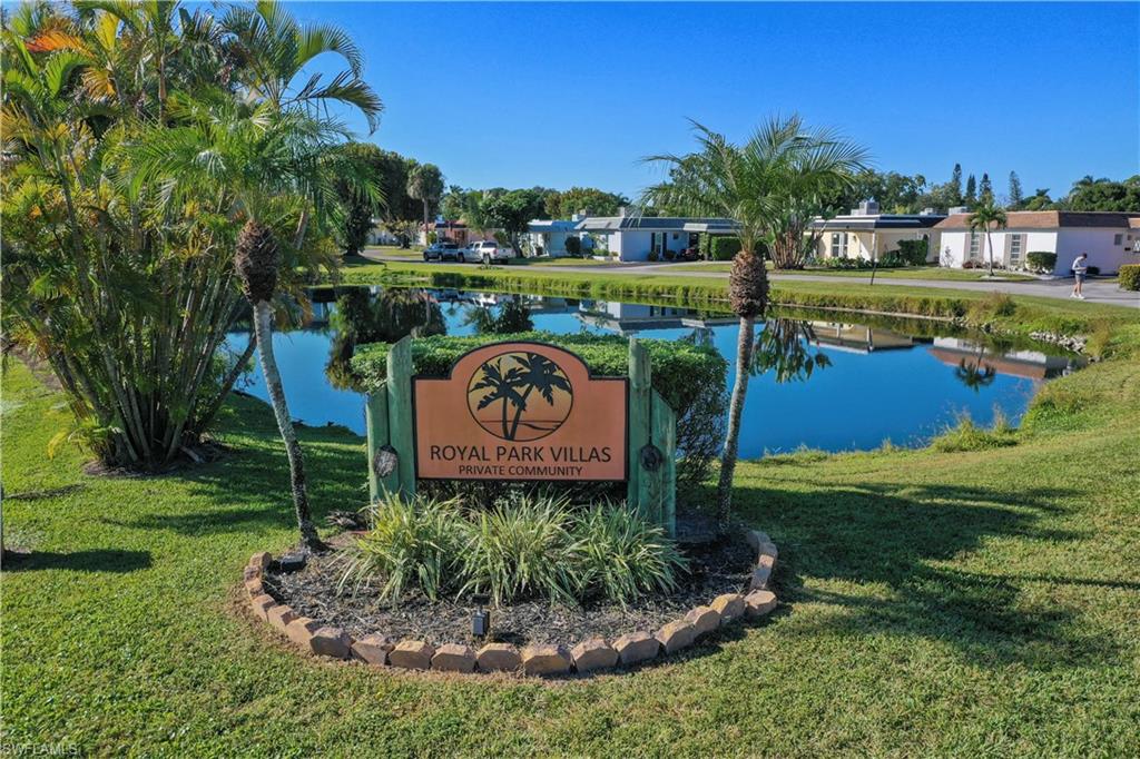 3 Kings Road, Unit A7 Naples, FL 34112 - Photo 19 of 20 Community sign featuring a lawn and a water view
