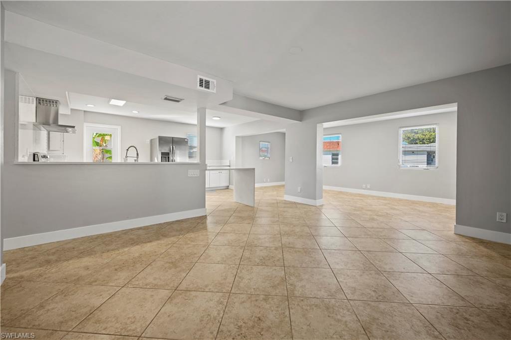 3 Kings Road, Unit A7 Naples, FL 34112 - Photo 4 of 20 Unfurnished living room with plenty of natural light, light tile patterned floors, and recessed lighting