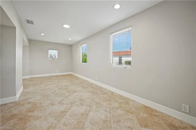 a view of a big room with windows and cabinet