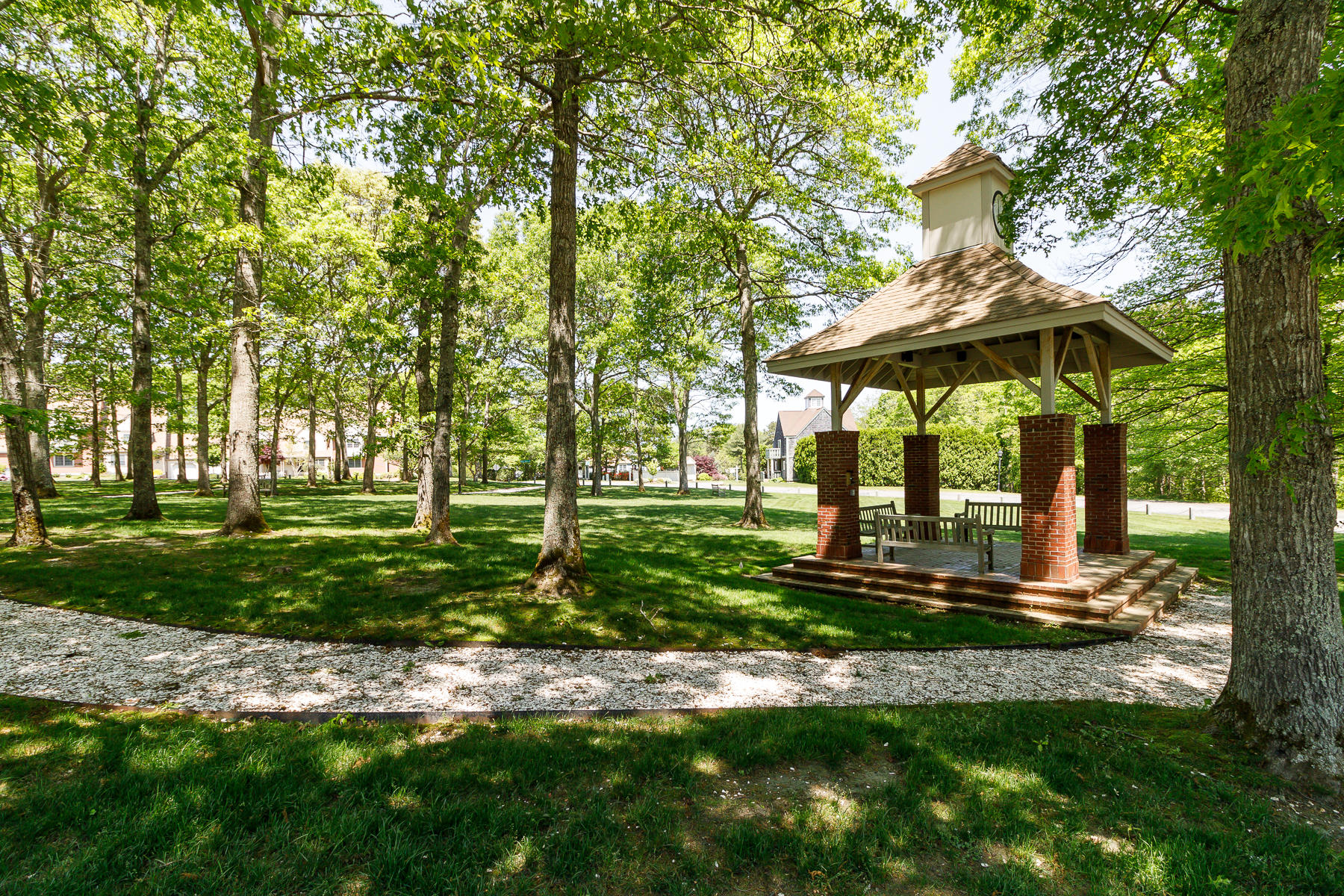 36 Windsor Point Mashpee, MA 02649 - Photo 2 of 23 a view of a backyard with table and chairs under an umbrella