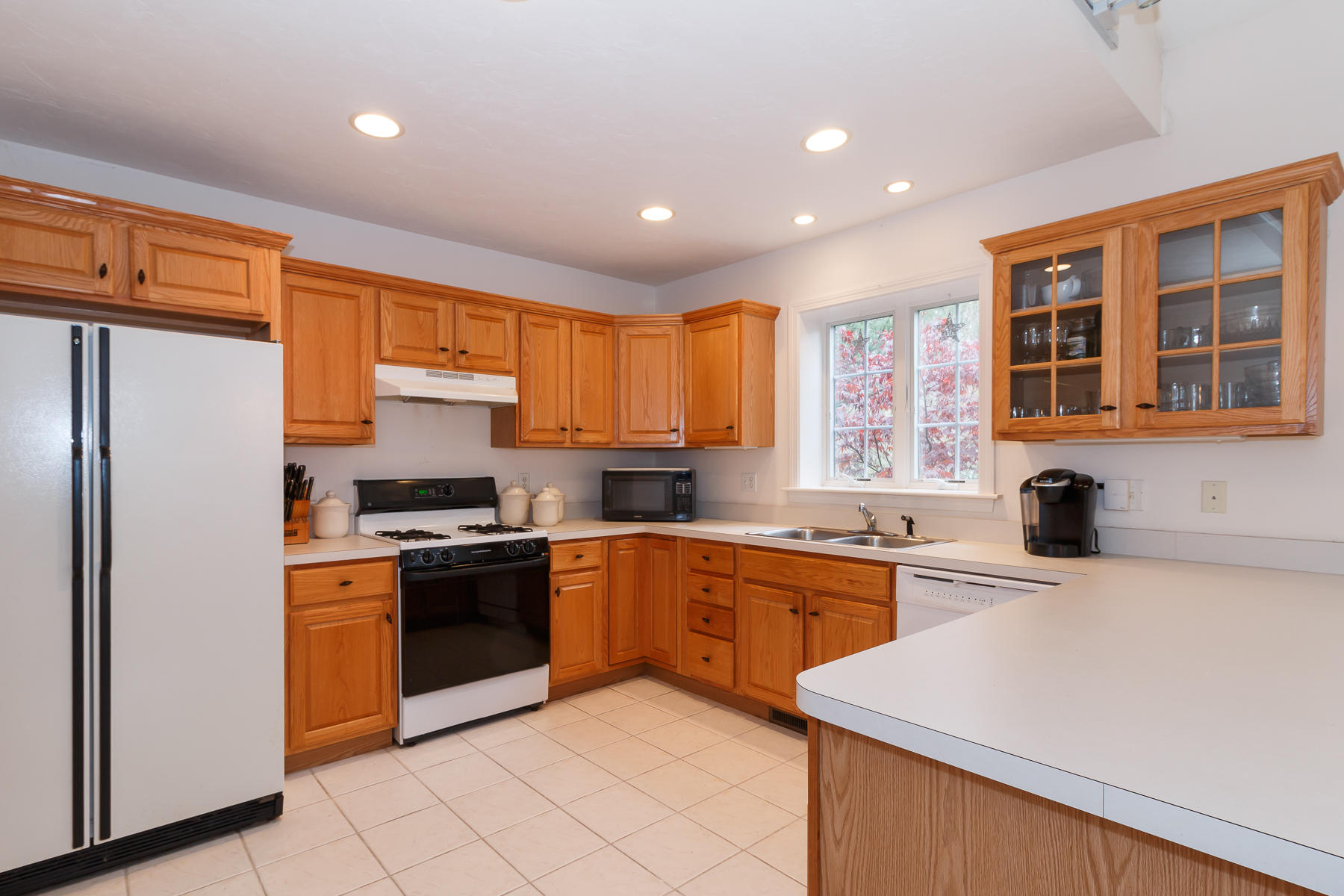 36 Windsor Point Mashpee, MA 02649 - Photo 10 of 23 a kitchen with stainless steel appliances granite countertop a stove sink refrigerator and cabinets