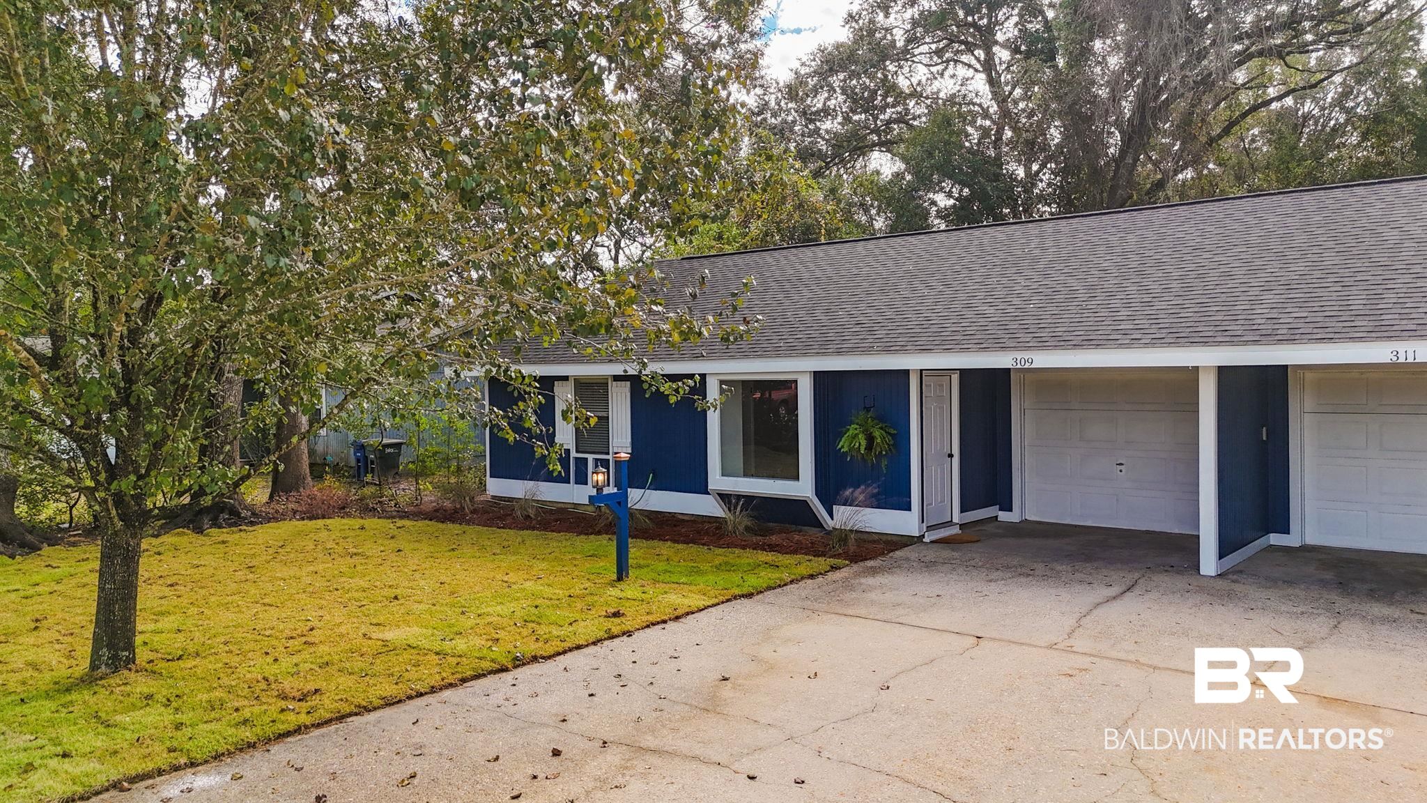 309 West Roosevelt Avenue Foley, AL 36535 - Photo 5 of 60 Ranch-style home with a garage and a front yard