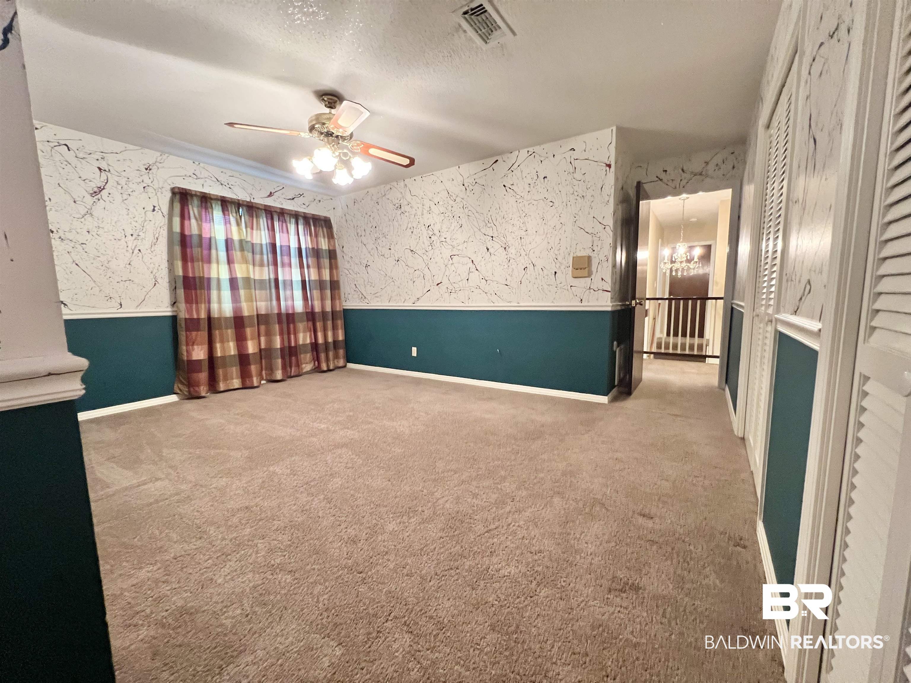 2691 Appleton Road Brewton, AL 36426 - Photo 40 of 60 Spare room featuring a chandelier, carpet floors, a textured ceiling, and ceiling fan